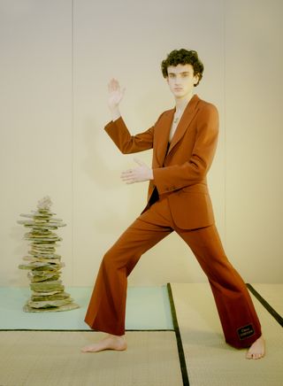 man in orange suit making tai chi poses