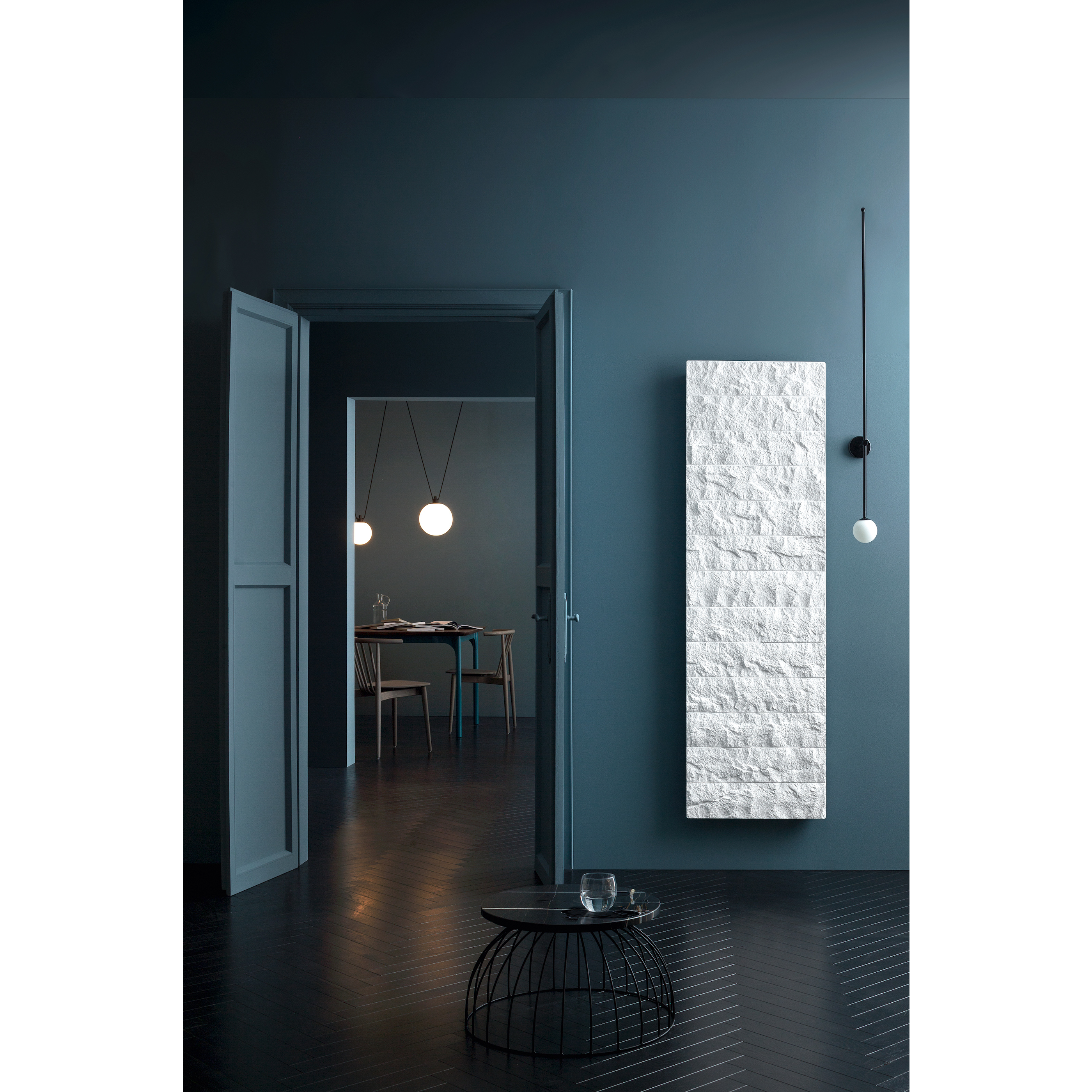 A dark blue bathroom with a textured white panel radiator featuring
