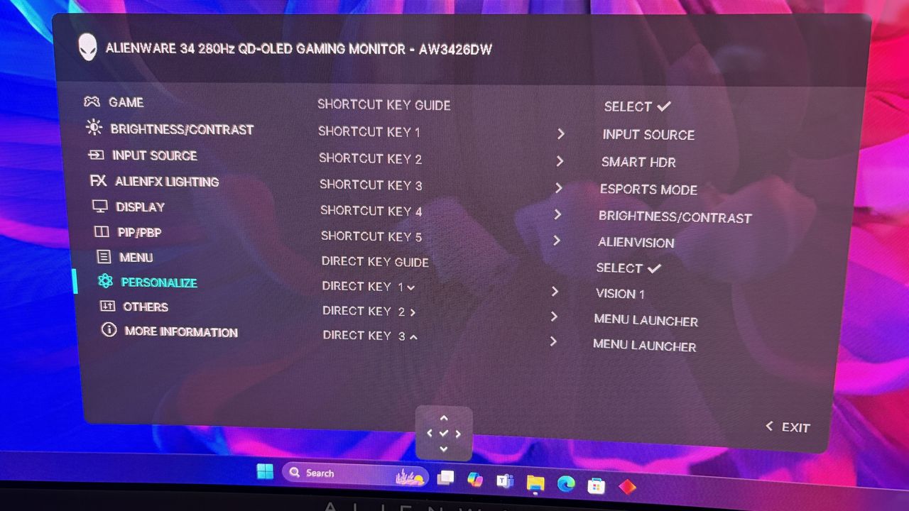 On-screen menu of an Alienware gaming monitor showing various settings like brightness, input source, and key guides against a colorful abstract background.