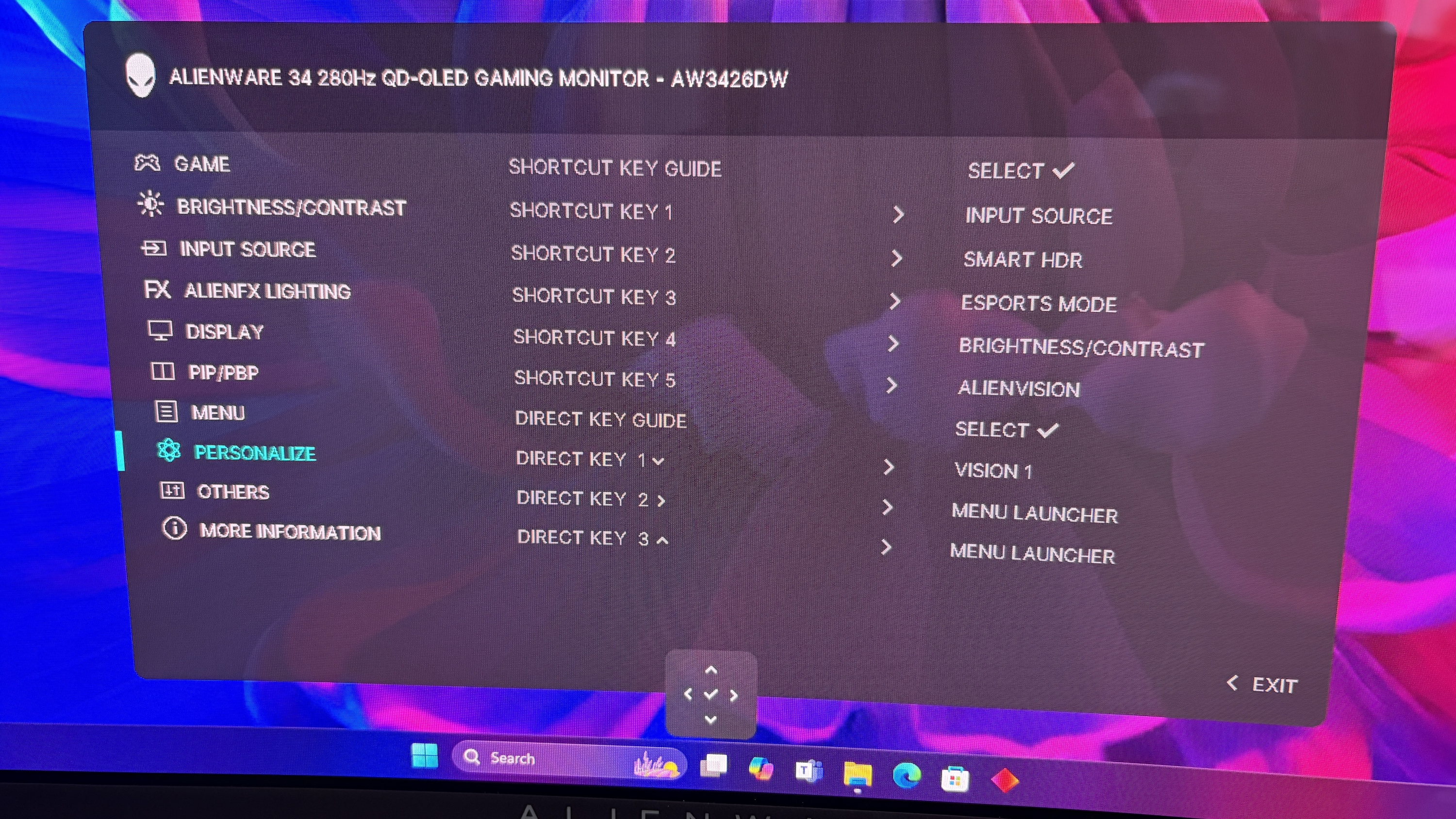 On-screen menu of an Alienware gaming monitor showing various settings like brightness, input source, and key guides against a colorful abstract background.