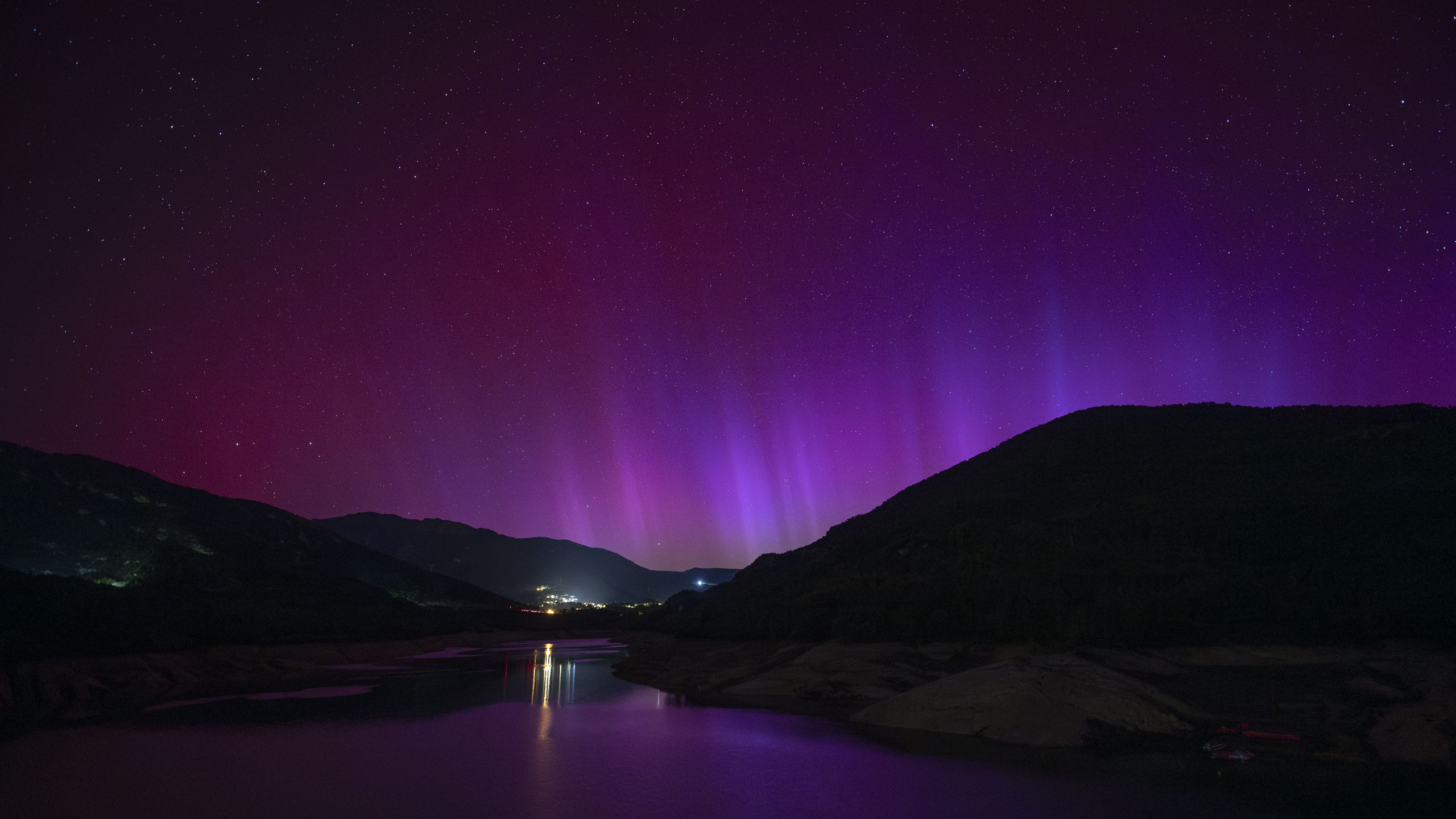 Photo: Space A bright purple sky above the silhouettes of mountains