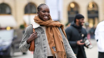 woman wearing a thick camel cashmere scarf top 