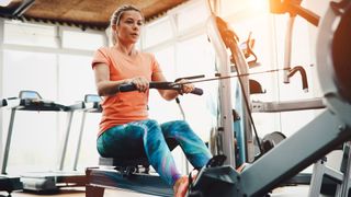 10 rowing machine benefits: image shows woman on rowing machine