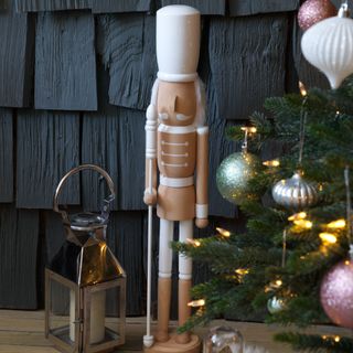 A Christmas tree with a minimalist Nucracker decoration