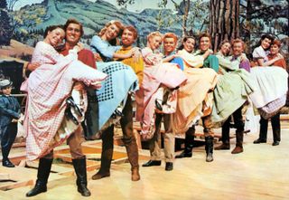 seven couples of men holding their female partner in their arms in the movie Seven brides for seven brothers