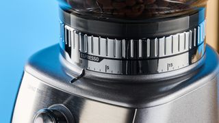 the breville dose control pro, called sage dose control pro in the uk, a silver coffee grinder with 60 grind settings and labeled grind size adjustment