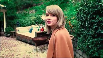 taylor swift and couch in garden