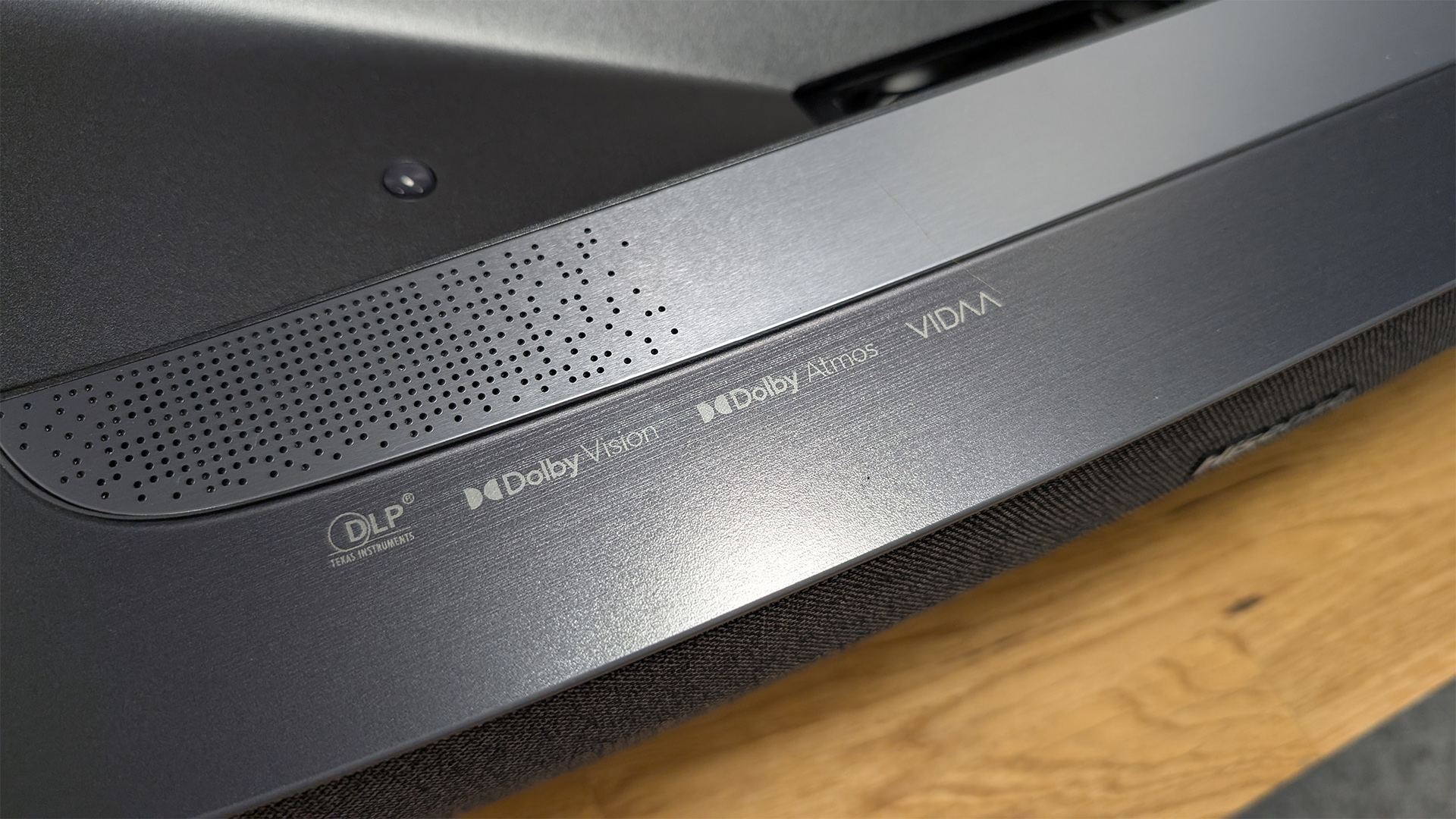 Hisense PL2 UST projector detail of edge of unit showing various logos and speaker grille