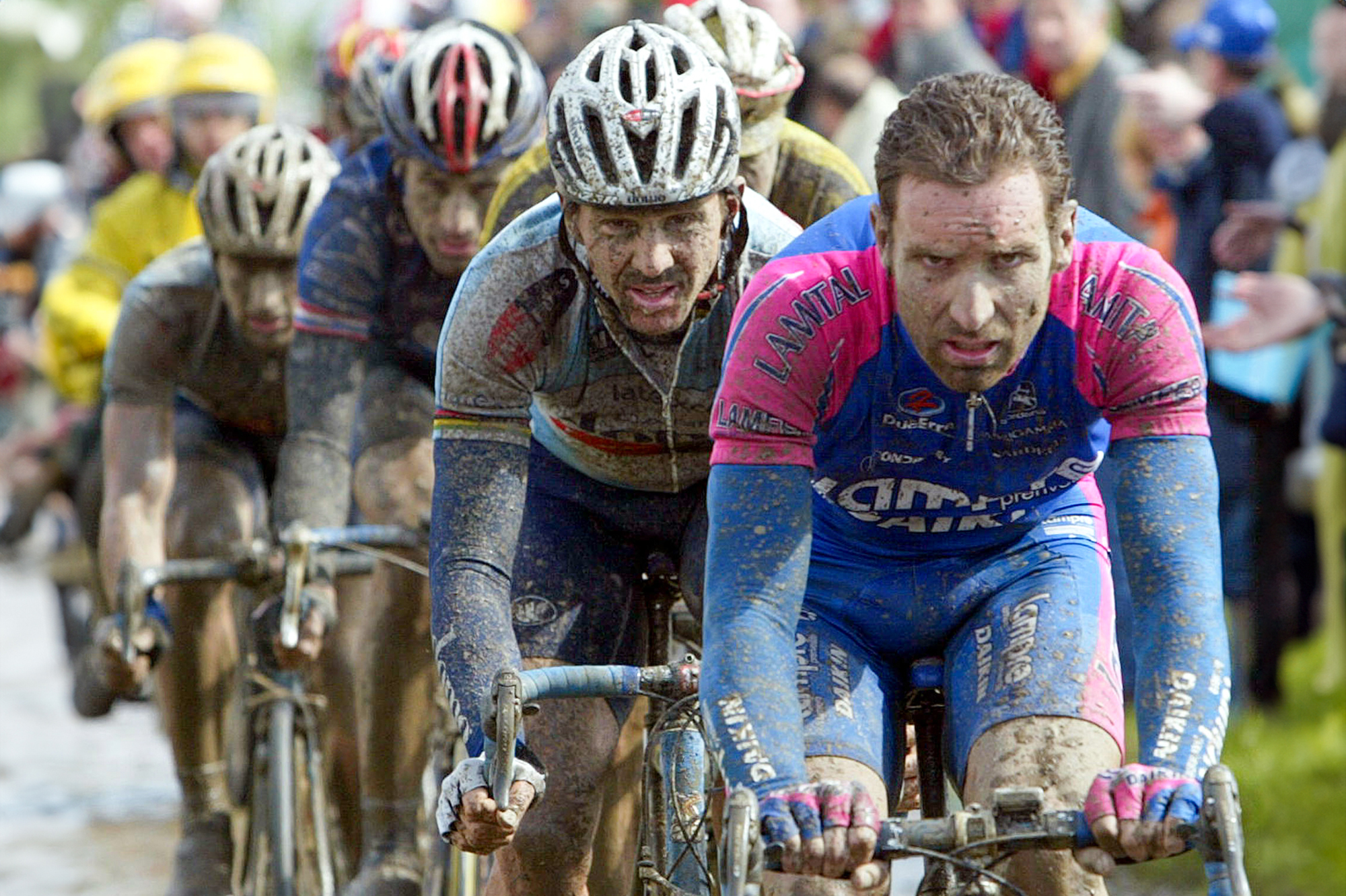 Zbigniew Spruch (Lampre-Daikin) leads Johan Museeuw (Domo-Farm Frites) and George Hincapie (US Postal Service) during the wet 2002 edition of Paris-Roubaix