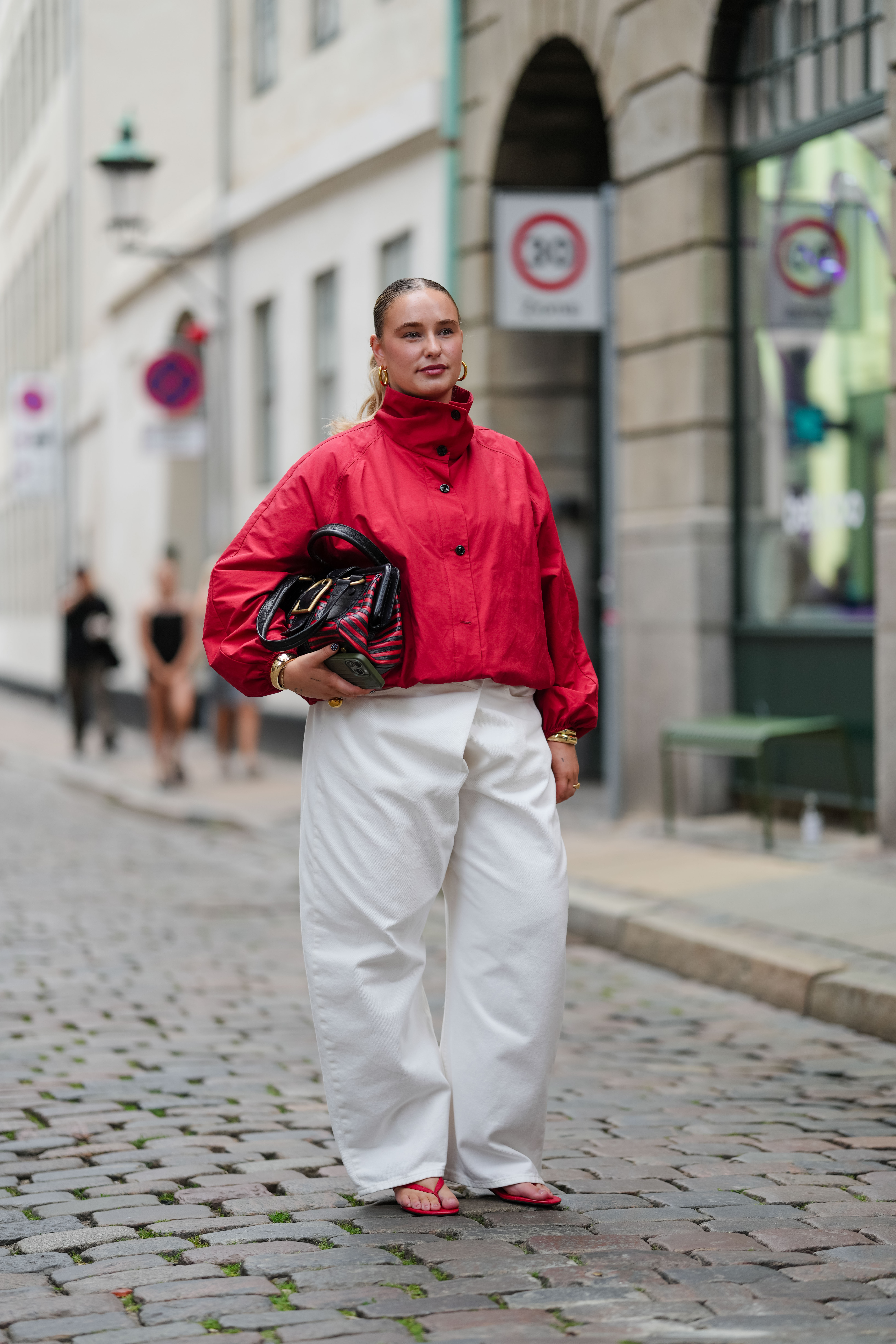 women at Copenhagen Fashion Week wearing flip flops with billowy pants and fall jackets