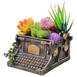 Resin typewriter-shaped planter with florals in it