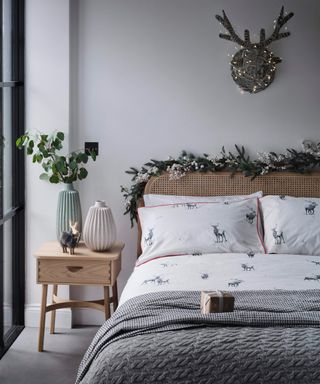 reindeer fairy light wall mount above bed in a grey bedroom - John Lewis