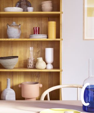 Decorating with primary colors - wooden shelving with display of ceramics and tableware