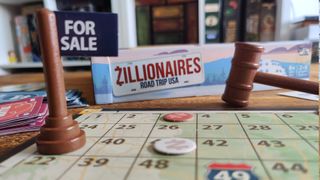 Zillionaires: Road Trip USA closeup of box, board, for sale sign, and gavel