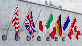 G7 member nation flags pictured on a wall