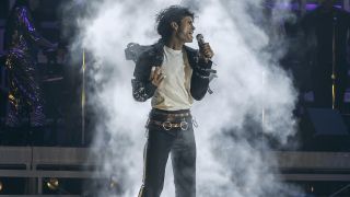 Jaafar Jackson as Michael Jackson on stage with smoke behind him