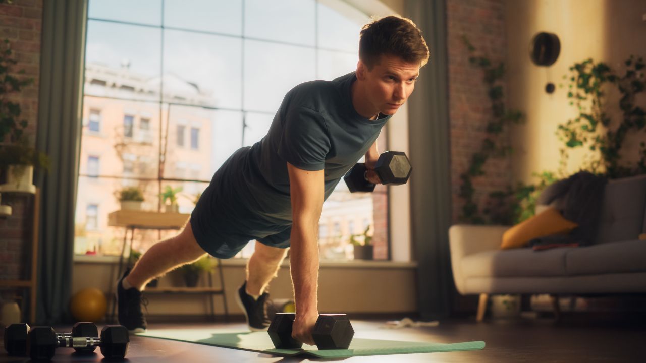 Man doing dumbbell renegade rows