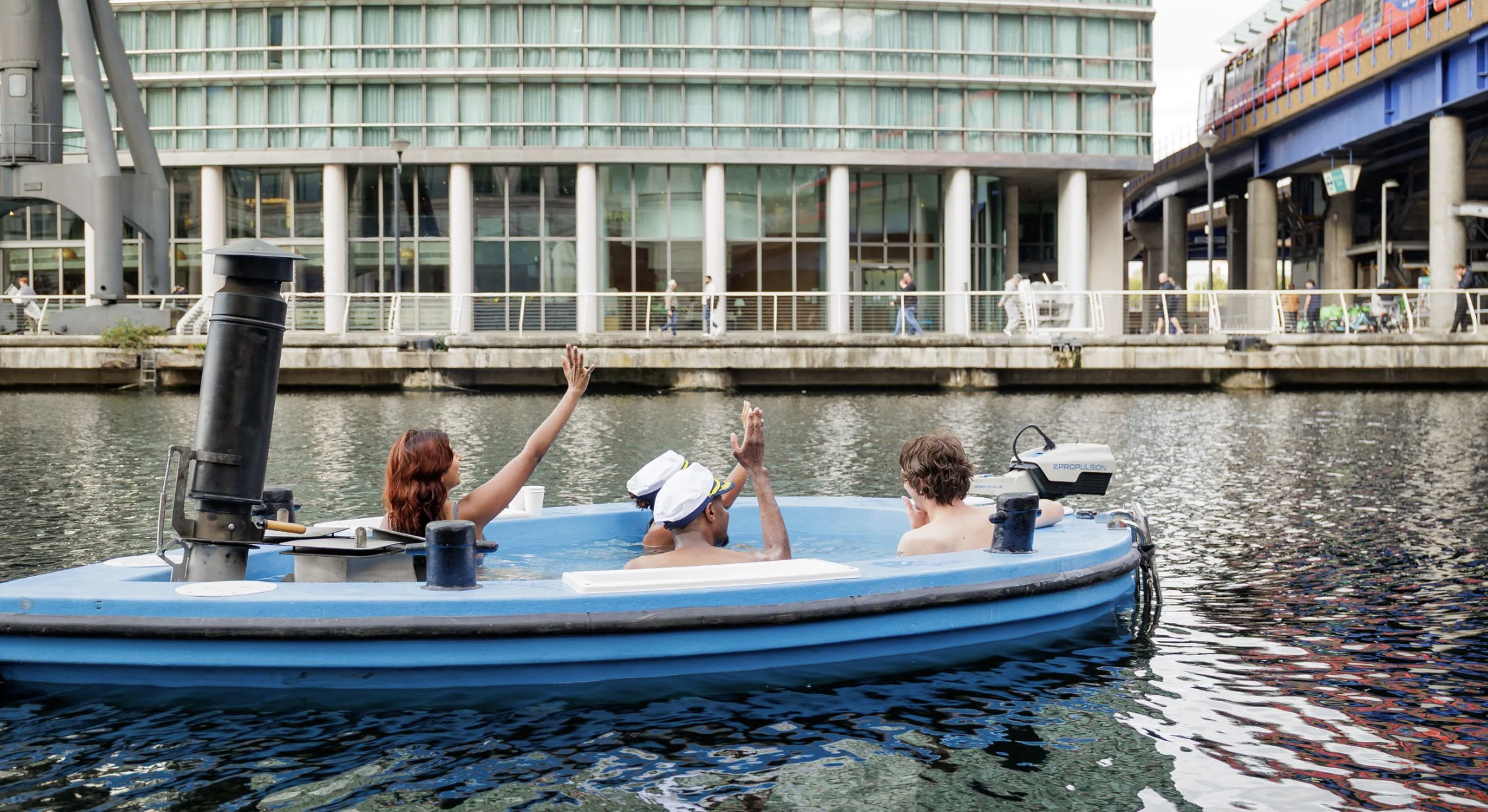 an image of four people in a boat that is actually a hot tub cruising down the river thames