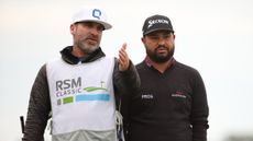 Mark Carens gestures forward with his hand while stood next to JJ Spaun at the 2024 RSM Classic