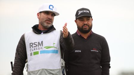 Mark Carens gestures forward with his hand while stood next to JJ Spaun at the 2024 RSM Classic