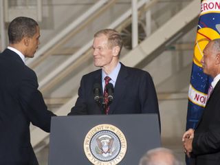 In the Operations and Checkout Building at NASA's Kennedy Space Center in Florida, President Barack Obama greets U.S. Sen. Bill Nelson before addressing the participants of the Conference on the American Space Program for the 21st Century as NASA Administ