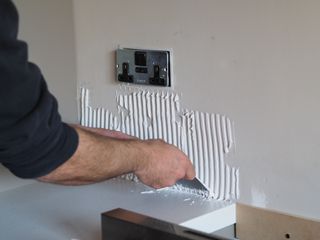 applying adhesive with a notched trowel