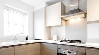 White and wood kitchen with stainless steel extractor fan