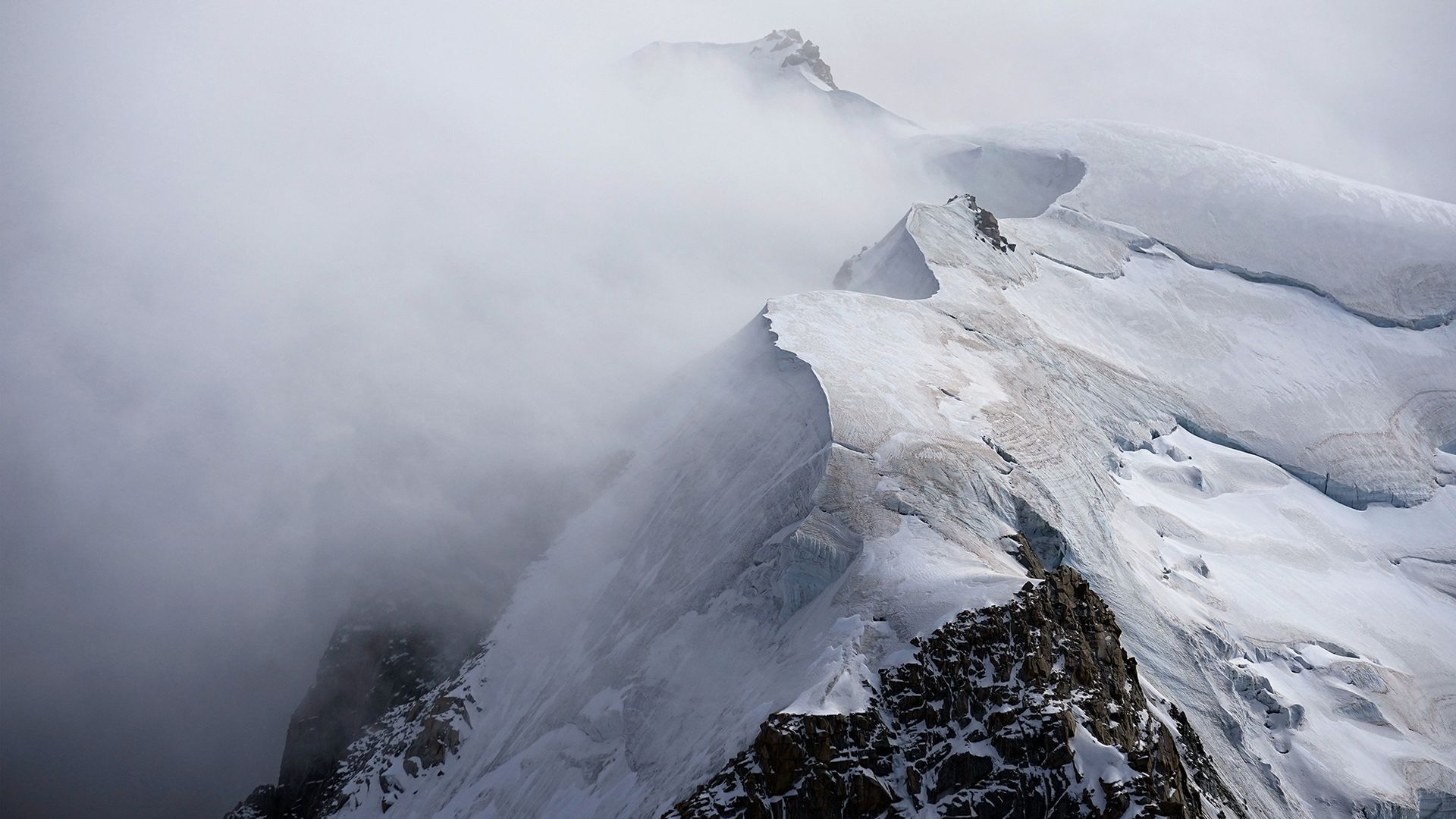 
                                Cloud sweeps across the Mont Blanc massif near Aiguille du Midi in Chamonix, France
                            