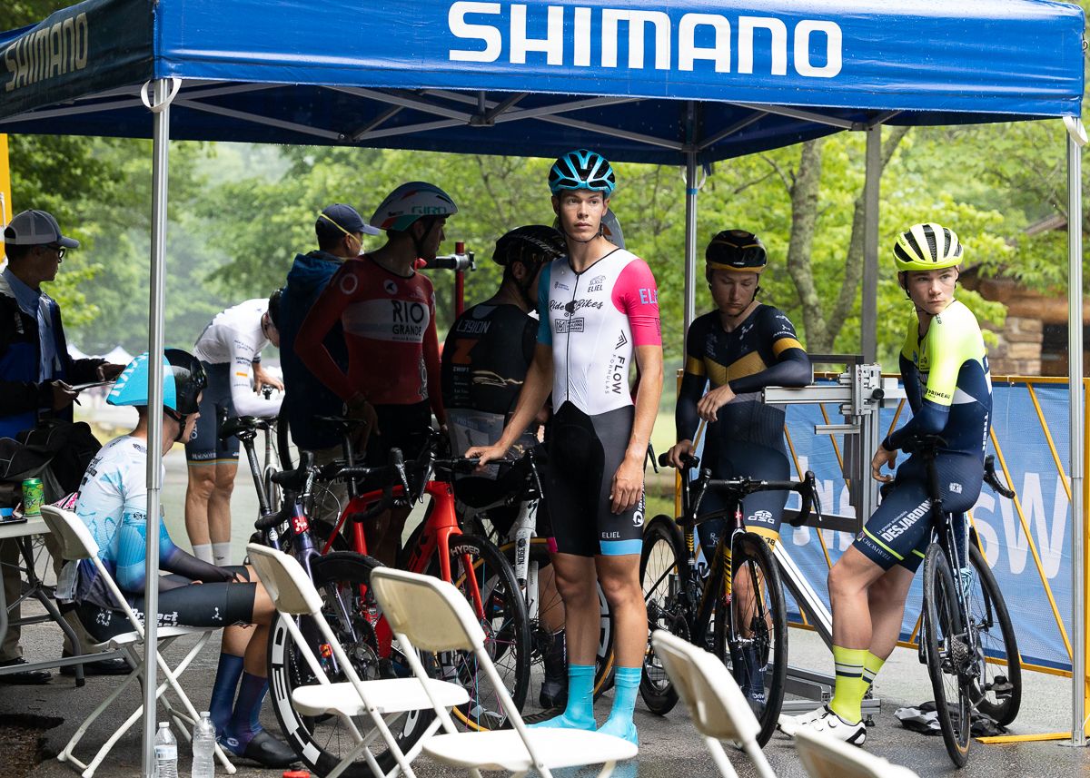 Preston Glace (RideBikesBros), Phillipe Jacob (Desjardin), Tyler Williams (L39ION of Los Angeles), Tayne Andrade (Rio Grande Elite Cycling), take shelter under the Shimano neutral support tent as the rain started to fall in Devil's Den.