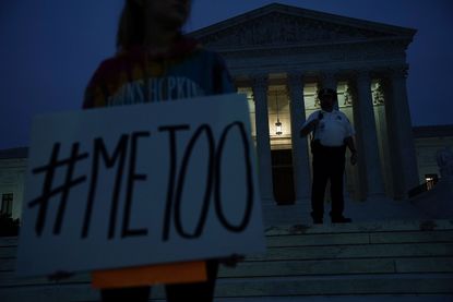An activist protests against the nomination of Supreme Court Judge Brett Kavanaugh in front of the U.S. Supreme Court