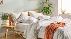 Three Brooklinen Down Pillows on an artfully distressed bed.