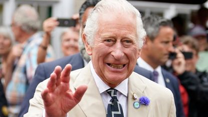 Prince Charles, Prince of Wales waves to members of the public during a visit to Cockington Court, a centre of creativity which is operated by Torbay Coast and Countryside Trust on July 20, 2022 in Torquay, United Kingdom. The Duke and Duchess of Cornwall are on a 3-day visit to the southwestern region to celebrate the Prince of Wales' 70th year as the Duke of Cornwall.