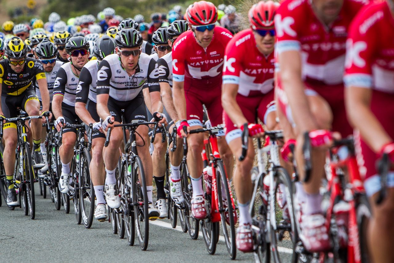 Mark Cavendish (Dimension Data) sits back in the field with his teammates