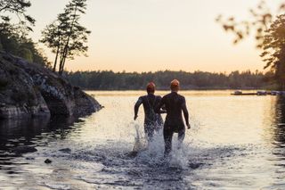Swimmers entering a lake