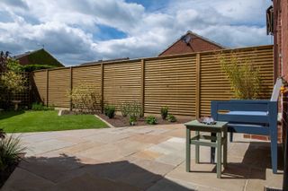 honey-hued wooden fence by Jacksons Fencing around garden