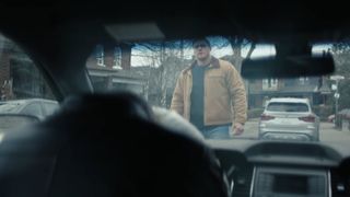 Jack Reacher seen through a car window in Reacher season 2 episode 2.