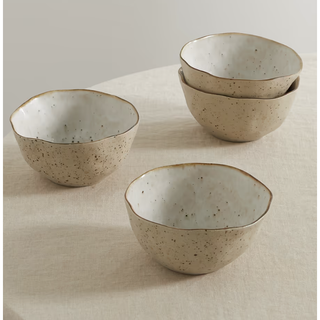 four glazed stoneware bowls in a rustic hand formed design