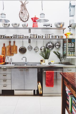 an industrial style kitchen with metal cabinets and open shelving