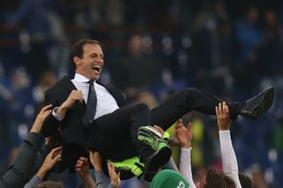 Juventus coach Massimiliano Allegri is lifted in the air by his players after winning the Scudetto in May 2015.