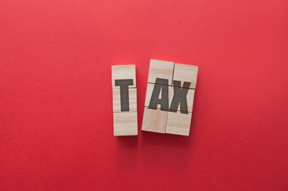 the word tax spelled out against a red background