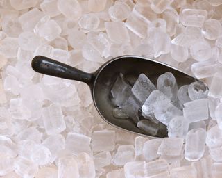 Scoop of ice in large full ice tray