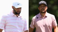 Scottie Scheffler looks down at the green, with Xander Schauffele walking off it