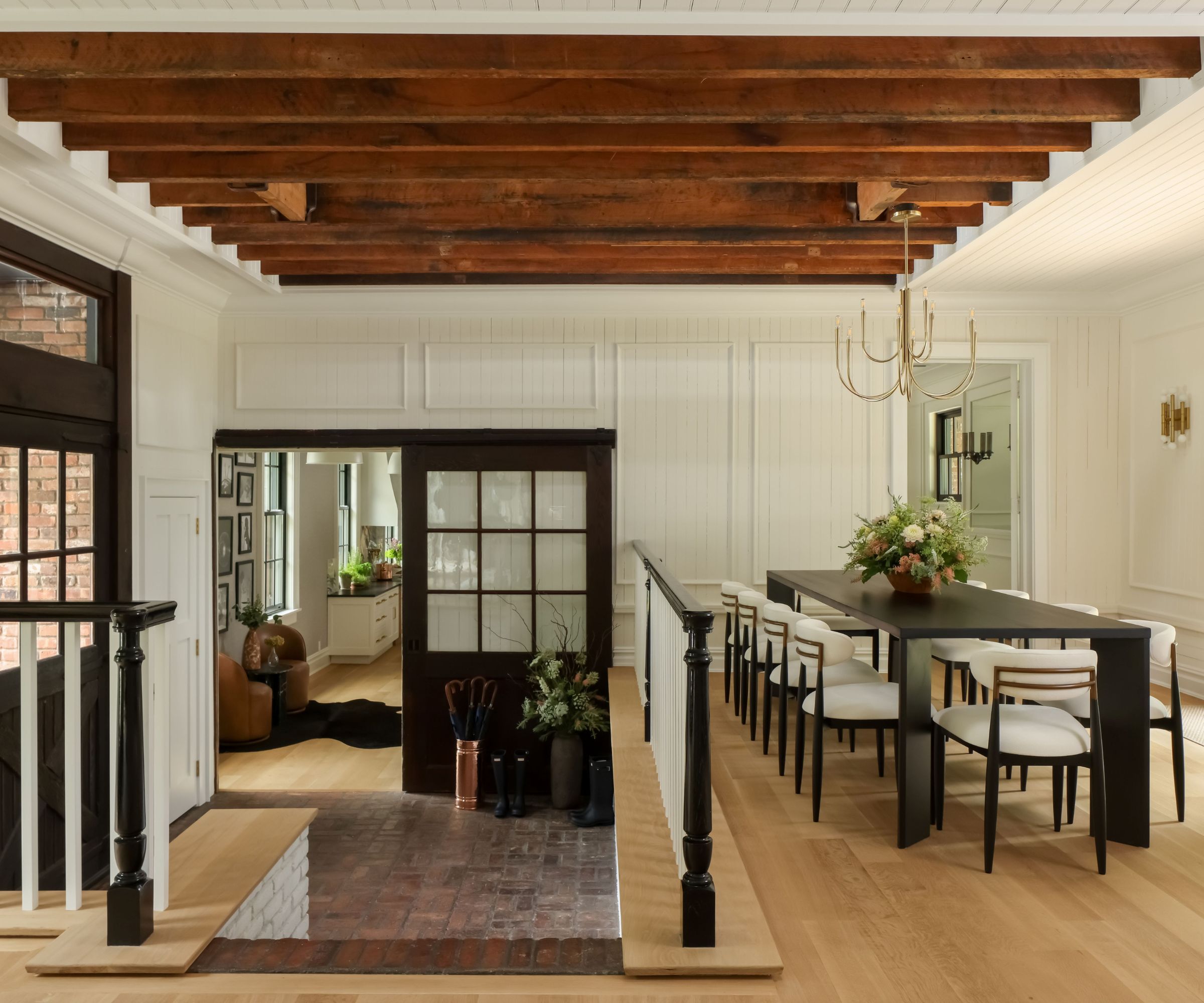 dining room with beams and paneled walls