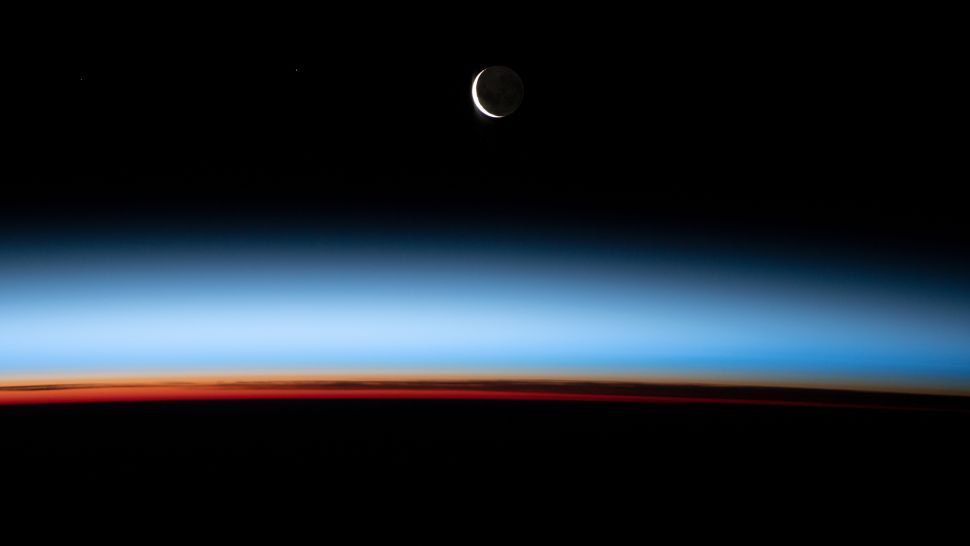Astronaut snaps spectacular shot of crescent moon glowing over stunning sunset