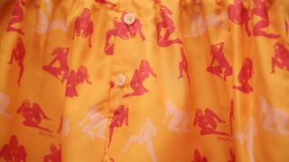A pattern of nude women printed on fabric.