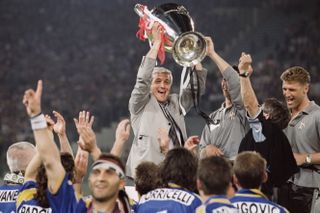 Marcello Lippi celebrates with the Champions League trophy after Juventus' win on penalties over Ajax in the 1996 final.