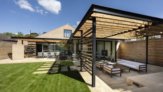 A remodelled 1970s bungalow with covered outdoor patio space and pristing lawn