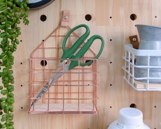 peg board with mounted basket and scissors