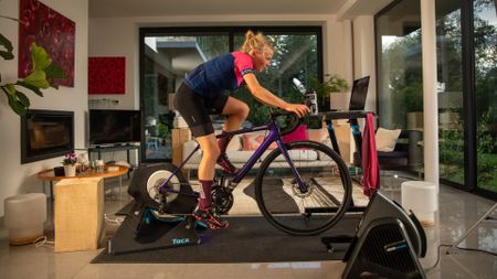 Image shows a rider using a turbo trainer indoors 