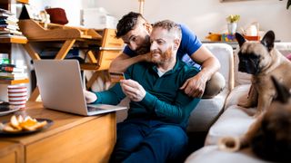 Male couple online shopping on their laptop